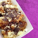 Banana & Cheese - Deep-fried banana fritters drizzled with salted caramel sauce, topped with shredded cheese & chocolate sprinkles.