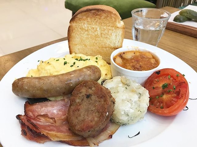 The English - scrambled eggs, back bacon, Cumberland pork sausage, sautéed mushrooms, baked beans, breakfast potatoes, grilled ripened vine tomato and signature brioche.