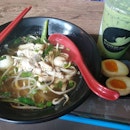 Chiang Mai chicken noodle soup with ramen egg and iced green milk tea.
