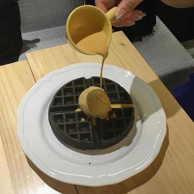 Salted caramel ice cream with charcoal waffles and salted egg yolk sauce.