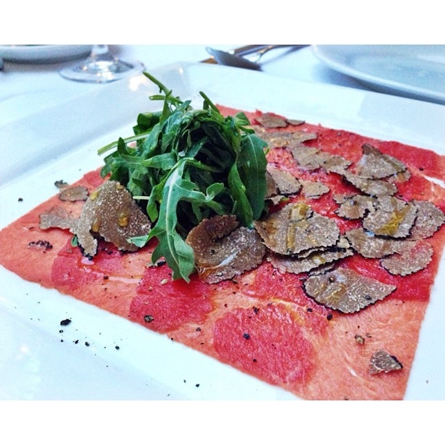 Wagyu beef carpaccio with rucola salad & shaved Scorzone summer black truffle.