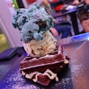 Charcoal waffles topped with Brownies & Cream and Cookie Monster Ice cream | $13.90