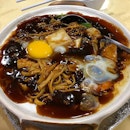 Bubbly claypot noodles with a fresh egg.