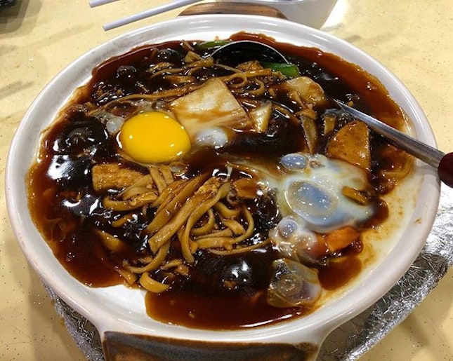 Bubbly claypot noodles with a fresh egg.