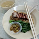 Breakfast starts with wan tan mee, served with crispy char siew slices.