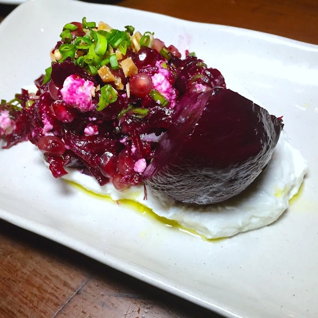 Beetroot wedge with pomegranate and roasted almonds and spring onion.