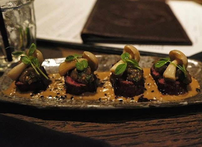 Flamed torched truffle beef with miso eggplant, shimeiji, and a sesame soy dressing.