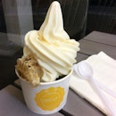 Frozen yoghurt from BeeGurt with raw honeycomb and fruits topping below.