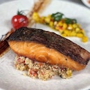 Crusted Baked Norwegian Salmon ($20.5++) nested on a bed of quinoa alongside mango salsa.