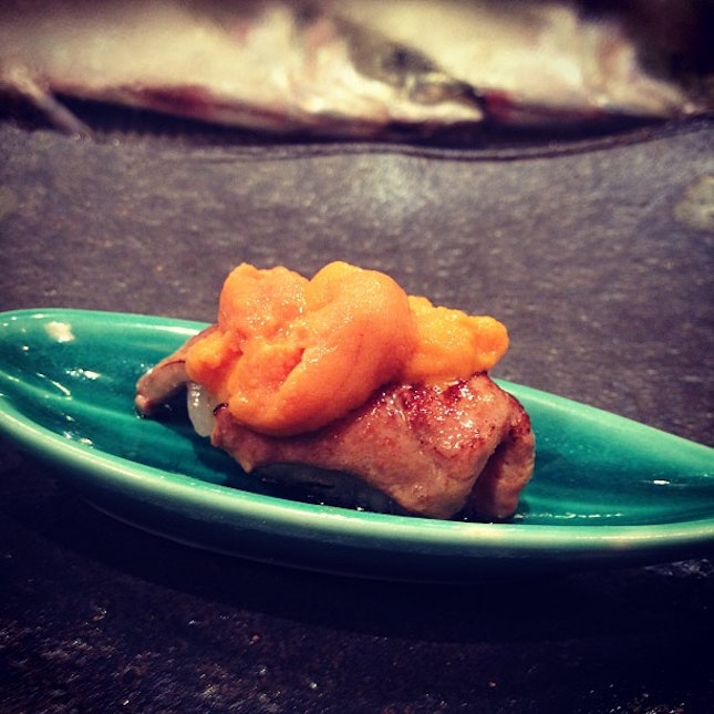Aburi foie gras sushi topped with uni.