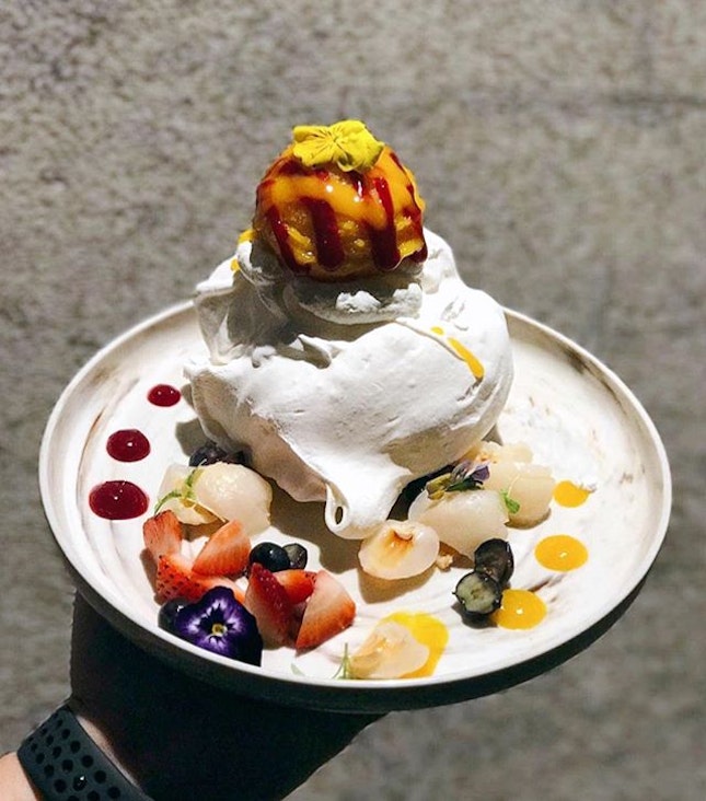 Medley of rose pavlova, alphonso mango sorbet, lychee and fresh berries to go with a meringue encasing light chantilly cream.
