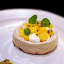 Sweet and tangy pavolo with yuzu, mango and passionfruit set on a cookie base with a delightful crunch.