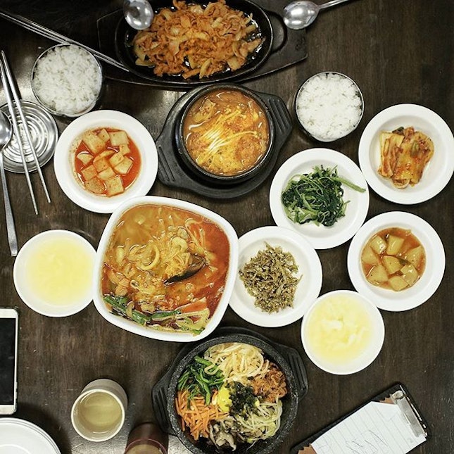 A table full of comfort Korean food, at a restaurant filled with Koreans.