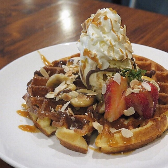 Freshly baked caramel banana waffle with honeycomb toffee ice cream, toasted almonds, strawberries and chocolate sauce.