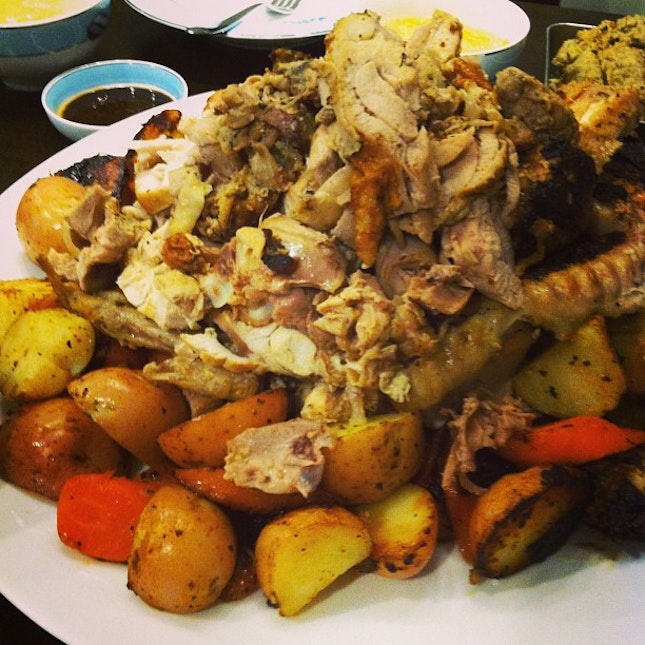 This is a cut up whole turkey with roast potatoes & carrot.